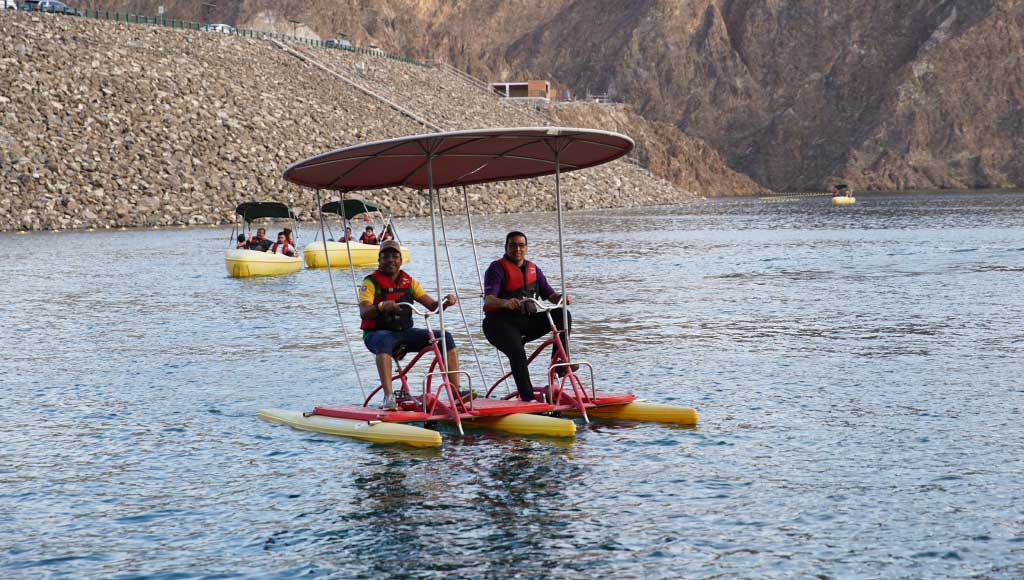 People surfing on the water - Camp Adventures - camping in uae